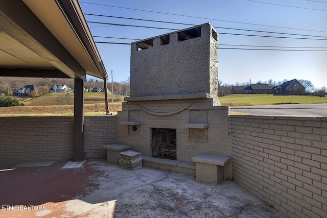 view of patio featuring exterior fireplace