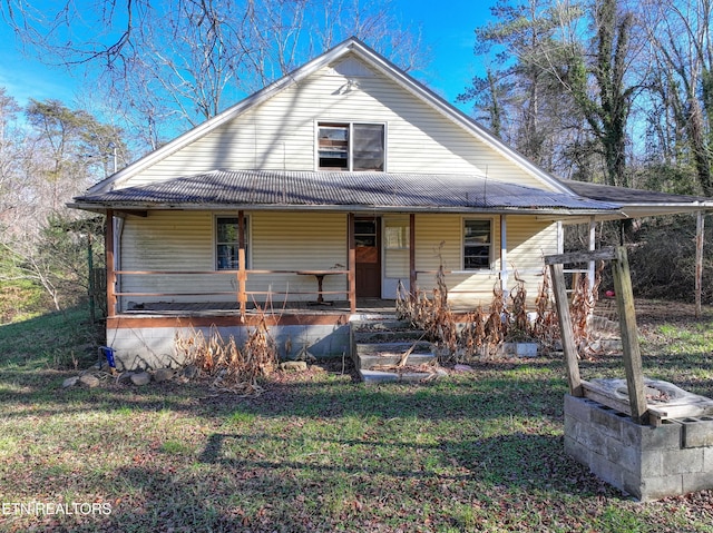 farmhouse inspired home with a porch and a front lawn