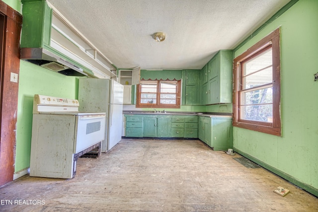 kitchen featuring a textured ceiling, green cabinets, sink, and white appliances