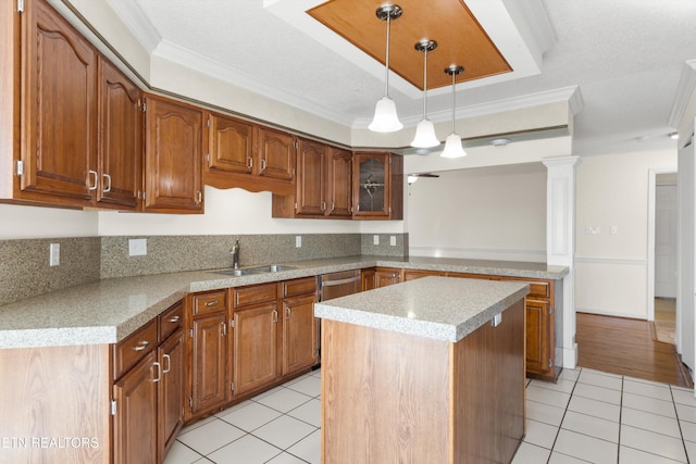 kitchen with a kitchen island, ornamental molding, light tile patterned floors, and sink