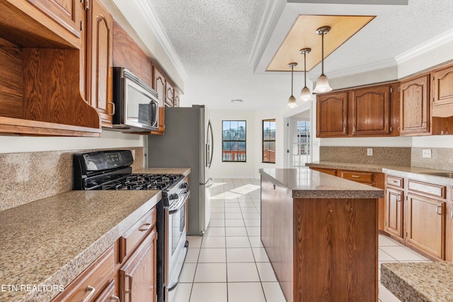 kitchen with ornamental molding, stainless steel appliances, light tile patterned flooring, and a kitchen island