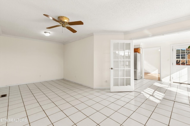 tiled empty room featuring ceiling fan, ornamental molding, and a textured ceiling