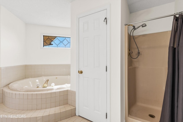 bathroom featuring a textured ceiling, tile patterned floors, and shower with separate bathtub