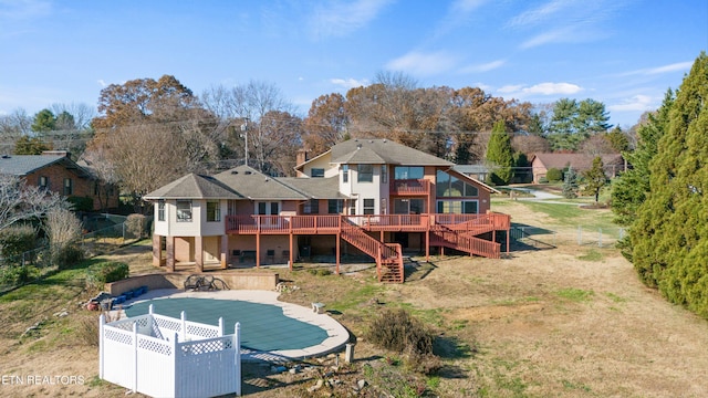 rear view of house featuring a deck and a yard