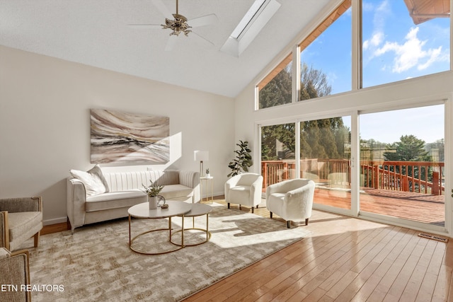 sunroom featuring ceiling fan and vaulted ceiling with skylight