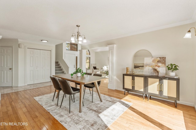 dining space with ornamental molding, an inviting chandelier, and wood-type flooring