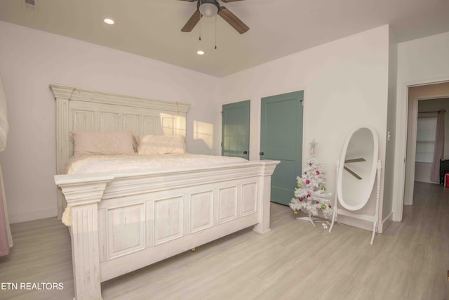 bedroom with ceiling fan and light wood-type flooring