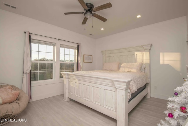 bedroom with ceiling fan and light wood-type flooring