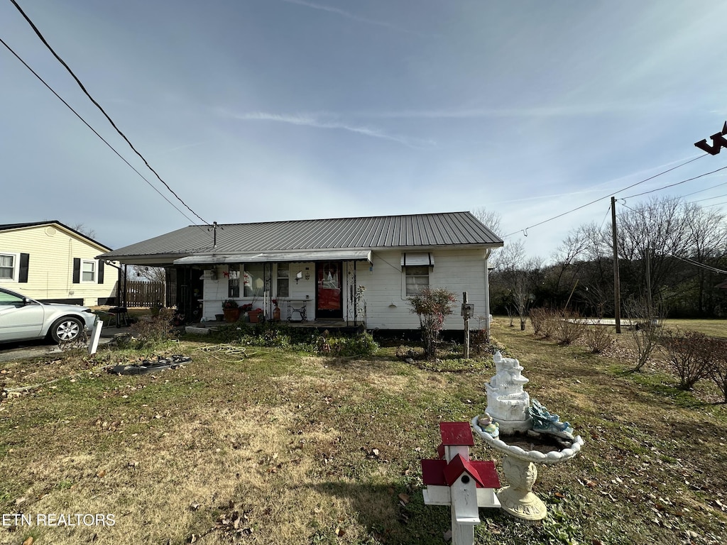 view of front of house with a front yard and a porch