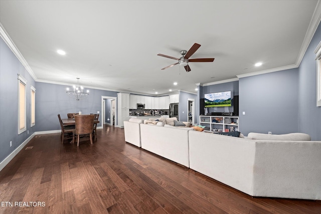 living room with ceiling fan with notable chandelier, dark hardwood / wood-style flooring, and crown molding