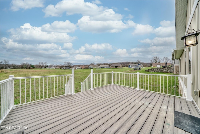 wooden deck featuring a yard