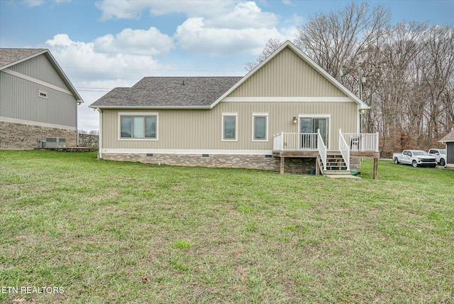 back of property featuring a lawn and central AC unit