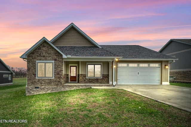 view of front of property featuring a yard and a garage