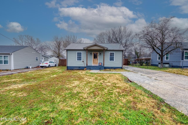 bungalow-style home with a front yard