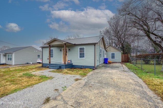 bungalow-style home featuring a front lawn