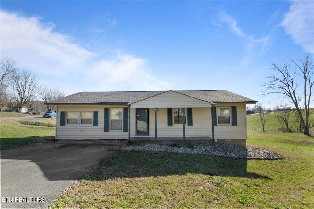 view of front of property with covered porch and a front lawn