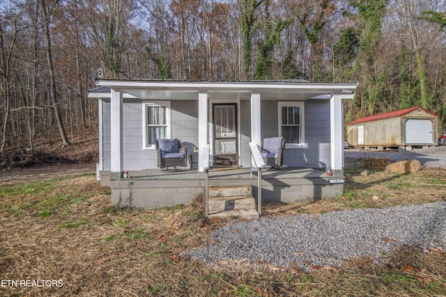 view of front facade featuring a porch and a shed