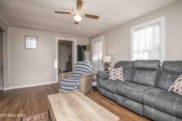 living room with dark hardwood / wood-style floors and ceiling fan