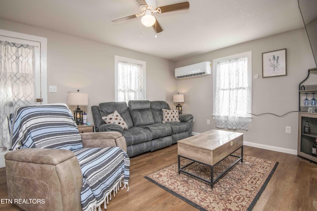 living room with hardwood / wood-style flooring, ceiling fan, and a wall mounted AC