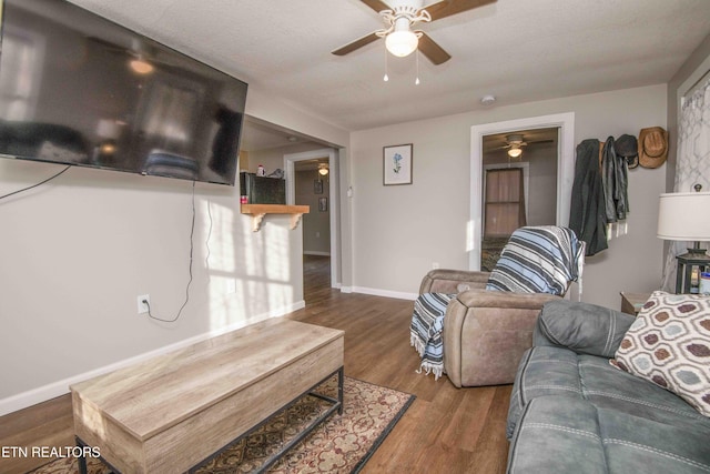 living room with wood-type flooring and a textured ceiling