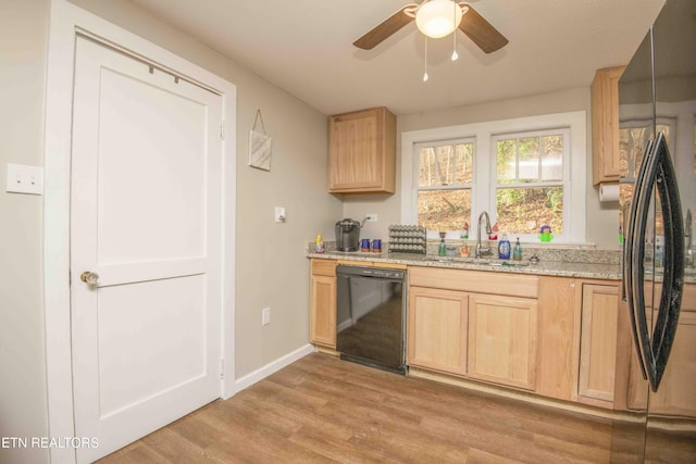 kitchen with sink, black dishwasher, light hardwood / wood-style flooring, fridge, and light brown cabinetry