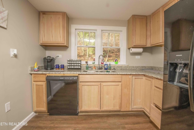 kitchen with black appliances, dark hardwood / wood-style floors, light brown cabinets, and sink