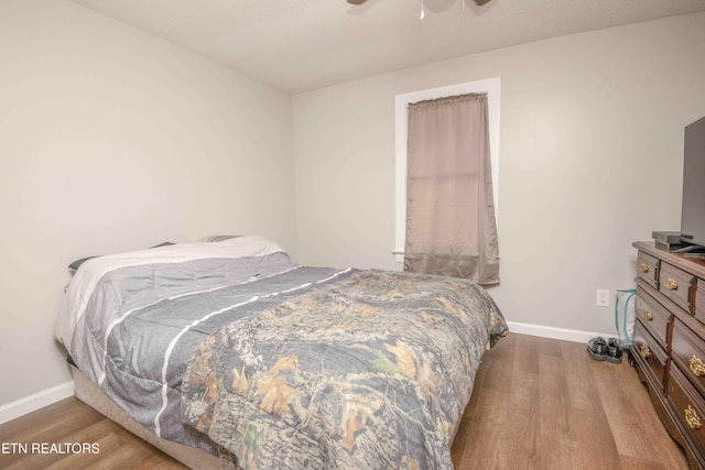 bedroom with ceiling fan and wood-type flooring