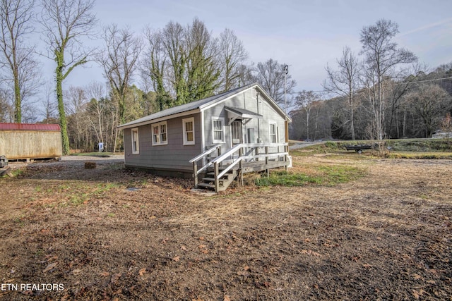 view of front of home with a storage shed