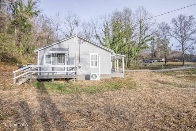 exterior space with ac unit and a wooden deck