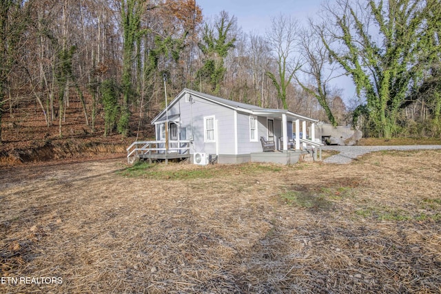 view of home's exterior featuring a wooden deck and ac unit