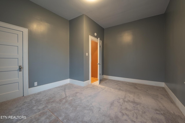 unfurnished room featuring light colored carpet