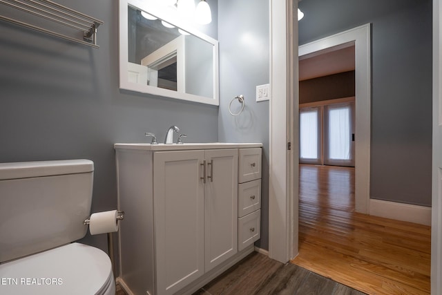 bathroom with vanity, hardwood / wood-style floors, and toilet