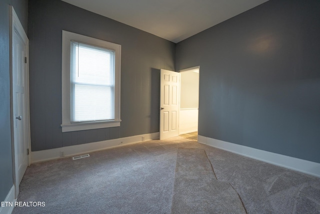 unfurnished bedroom with light colored carpet