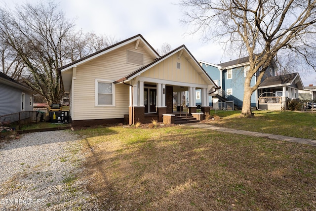 bungalow-style house with a front lawn and covered porch