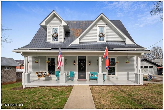 view of front of home featuring a front yard and covered porch