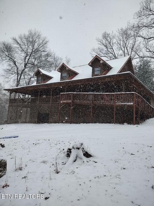 view of snow covered exterior featuring a deck