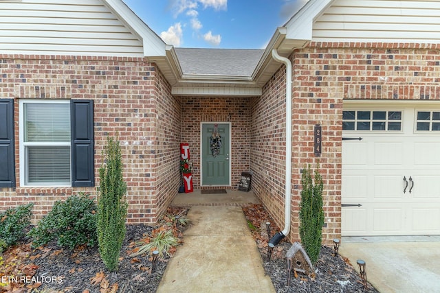 doorway to property with a garage