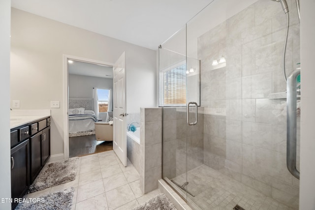 bathroom with separate shower and tub, vanity, and tile patterned flooring