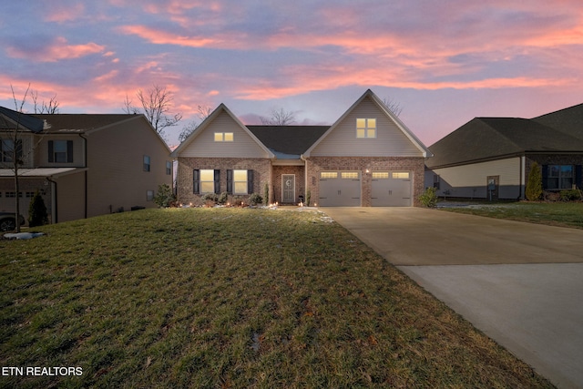 view of front of property featuring a garage and a lawn