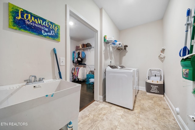 clothes washing area with sink and washing machine and clothes dryer