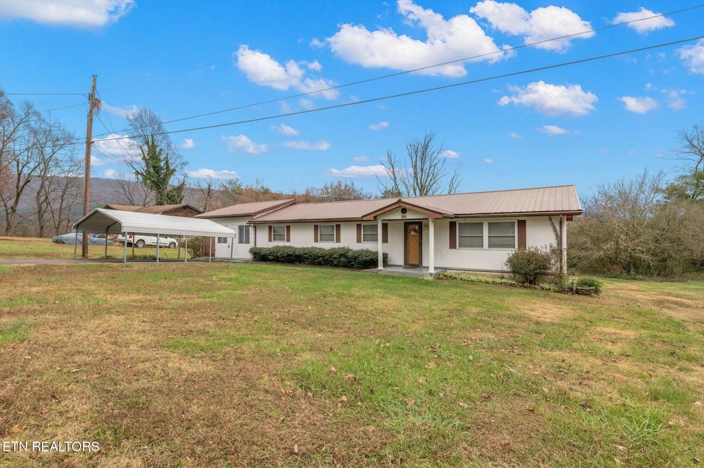 ranch-style home with a front lawn and a carport