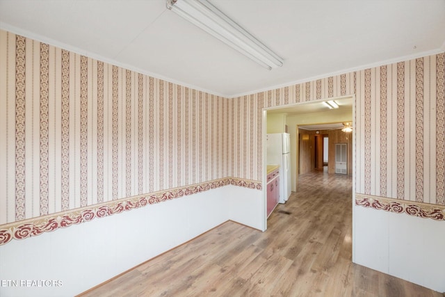 hall with wood-type flooring and crown molding