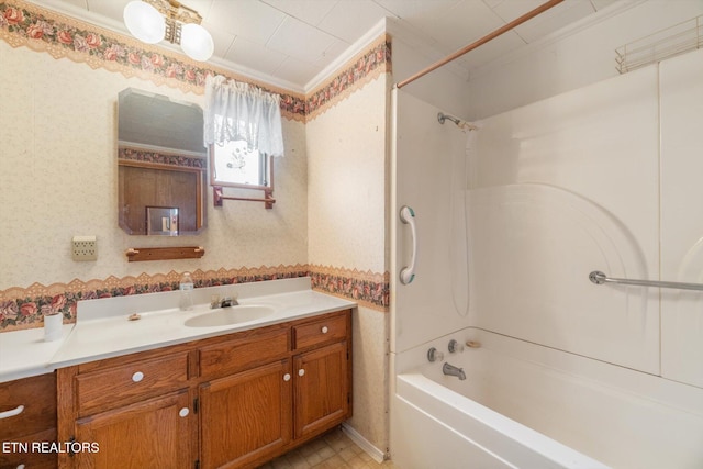 bathroom featuring shower / tub combination, vanity, and ornamental molding