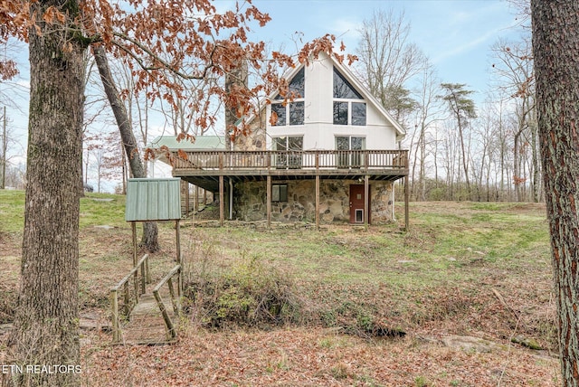 rear view of property featuring a deck