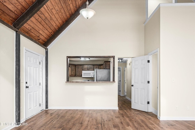 unfurnished living room with high vaulted ceiling, beam ceiling, wood-type flooring, and wood ceiling