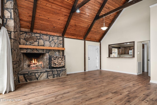 unfurnished living room featuring beam ceiling, wooden ceiling, high vaulted ceiling, a fireplace, and hardwood / wood-style flooring