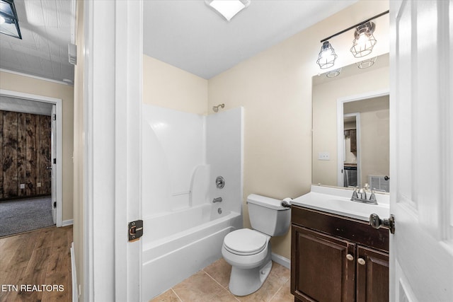 full bathroom with washtub / shower combination, hardwood / wood-style floors, vanity, and toilet