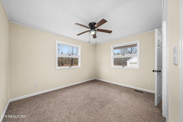 unfurnished room featuring carpet flooring, ceiling fan, and crown molding