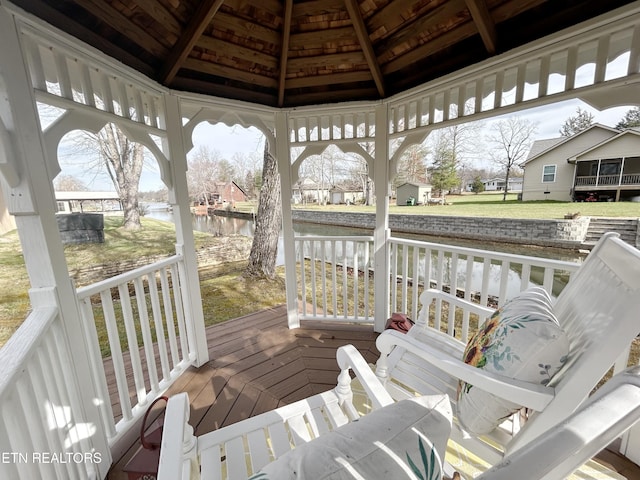 wooden terrace with a gazebo and a water view