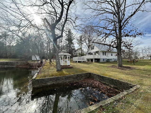 view of yard featuring a gazebo and a water view